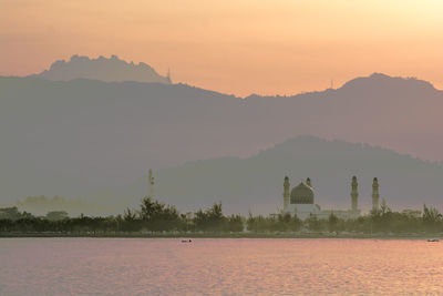 Scenic view of silhouette field against sky during sunset