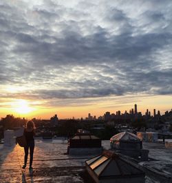 People in city against cloudy sky