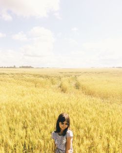 Scenic view of grassy field against sky