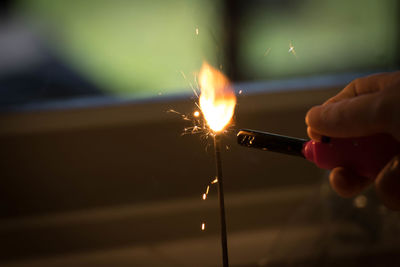 Close-up of hand holding illuminated lighting equipment