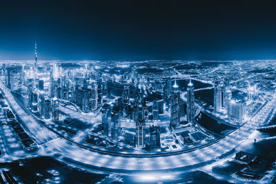 High angle view of illuminated buildings in city at night