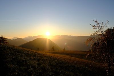 Scenic view of field against sky during sunset