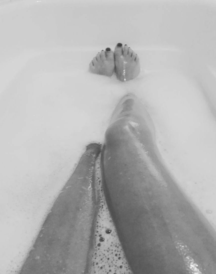 bathtub, human leg, human body part, domestic bathroom, low section, body part, bathroom, domestic room, taking a bath, one person, soap sud, wet, bubble bath, limb, hygiene, home, indoors, water, relaxation, human foot, human limb, beautiful woman