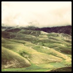 Scenic view of landscape against cloudy sky