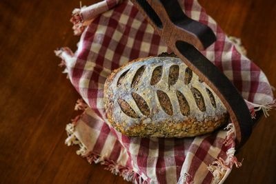 High angle view of person holding bread on table