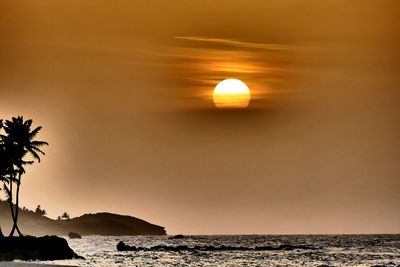 Scenic view of sea against sky at sunset