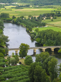 High angle view of river amidst trees against sky