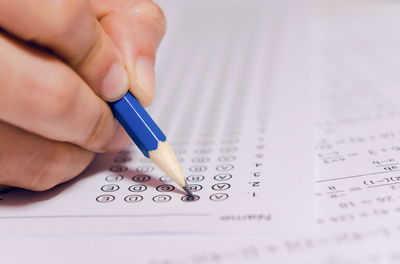 Close-up of human hand on paper