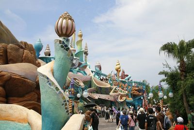 Group of people in traditional clothing against sky