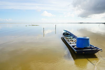 Ship floating on sea against sky