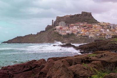 Scenic view of sea and buildings against sky