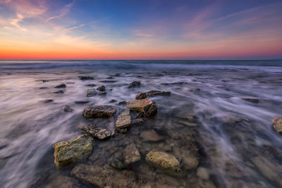 Scenic view of sea against sky at sunset