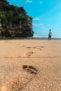 Close-up of footprints on beach
