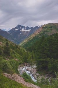 A picturesque landscape of a river flowing through the alps mountains in the valgaudemar valley
