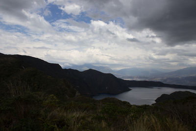 Scenic view of land and mountains against sky