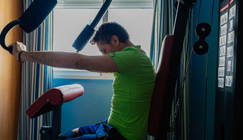 Side view of man skateboarding on window