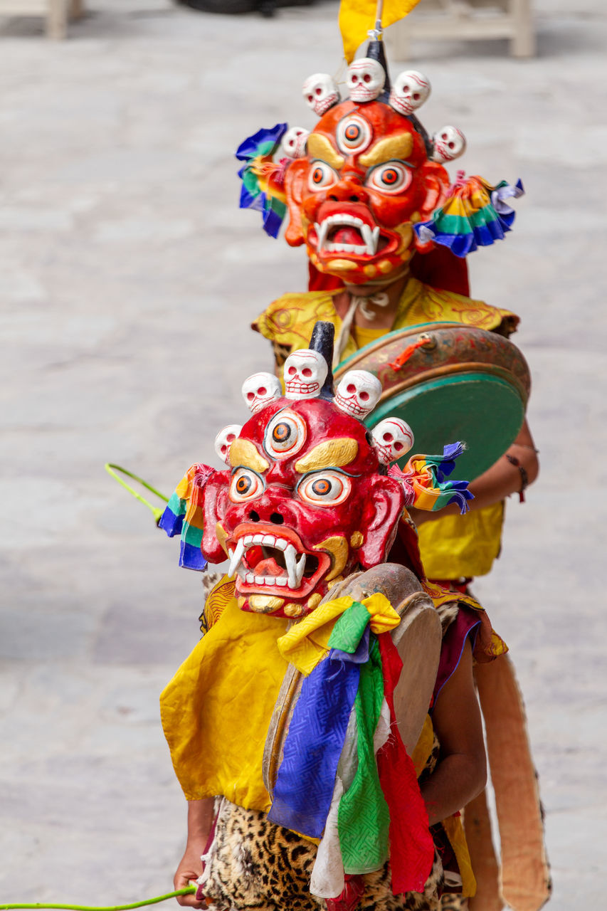 CLOSE-UP OF MULTI COLORED TOYS IN TRADITIONAL CLOTHING