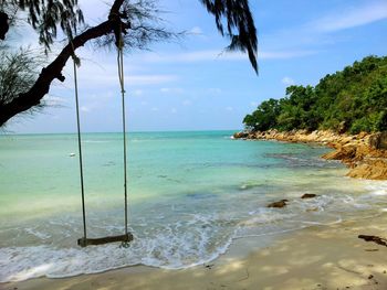 Empty swing hanging at beach