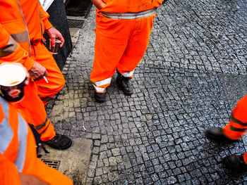 Low section of man standing on road