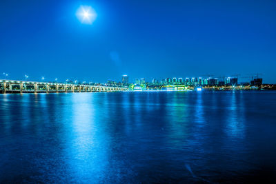 Illuminated city at waterfront