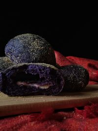 Close-up of cake on table against black background