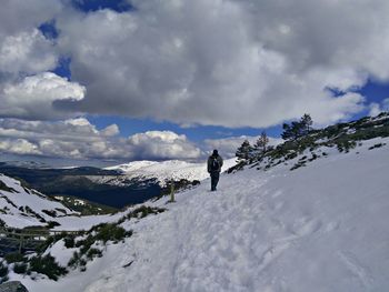 Man on snowcapped mountain against sky