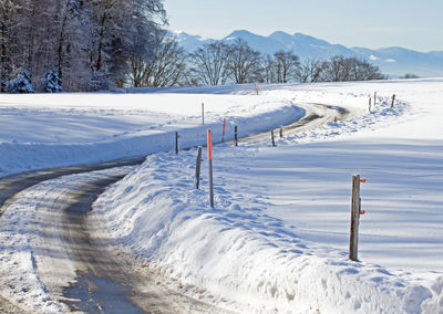 Scenic view of snow covered field against mountain