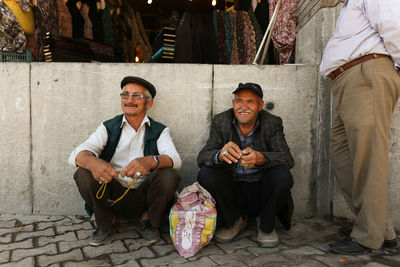 Portrait of happy friends sitting outdoors