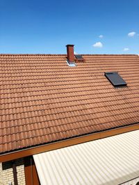 High angle view of house roof against blue sky