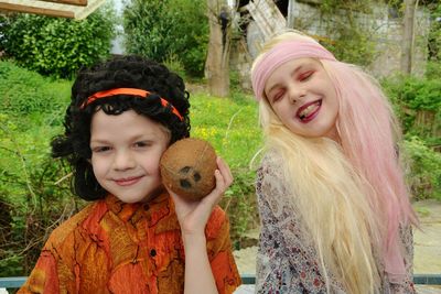 Children in costumes standing against plants