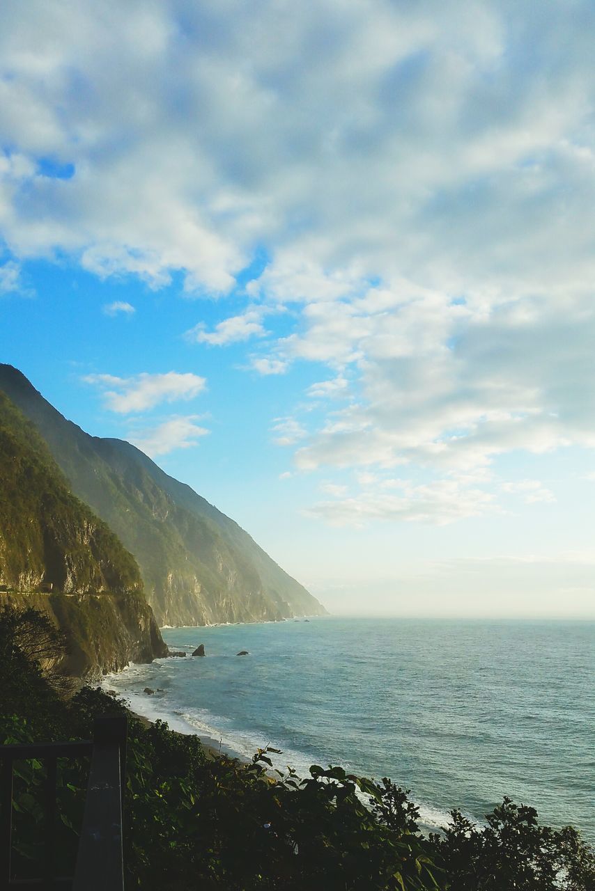 sea, water, sky, scenics, tranquil scene, beauty in nature, tranquility, horizon over water, cloud - sky, nature, beach, shore, mountain, cloud, idyllic, cloudy, coastline, day, outdoors, tree