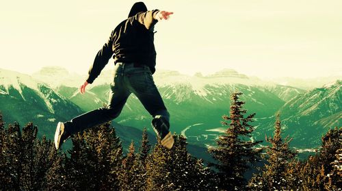 Man jumping for joy in mountains