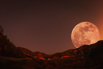 Scenic view of mountains against sky with full moon