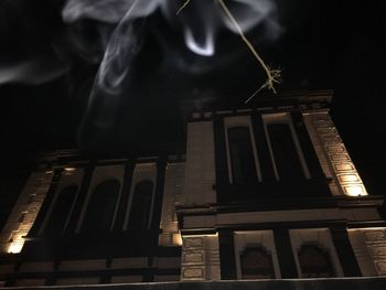 Low angle view of illuminated building at night