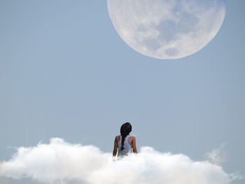 Low angle view of kites against blue sky