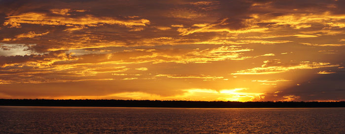 Scenic view of dramatic sky over sea during sunset