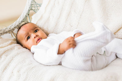 High angle view of baby boy sleeping on bed at home