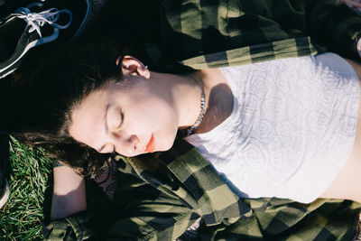 Portrait of young woman lying on bed