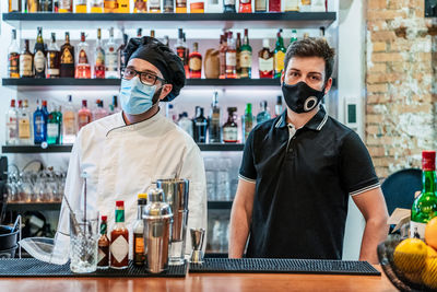 Full length of a man standing by bottles