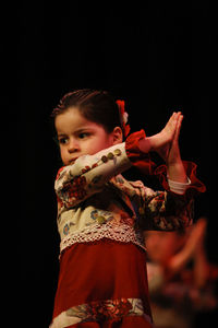 Portrait of a boy against black background