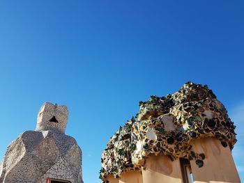 Low angle view of statue against clear blue sky