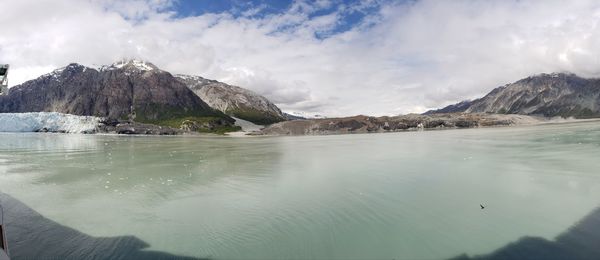 Scenic view of sea and mountains against sky