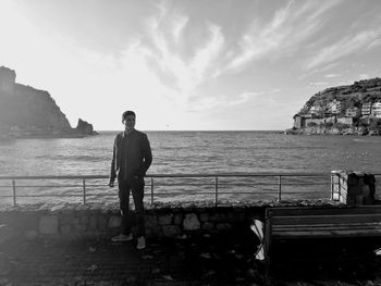 Full length of man standing by sea against sky