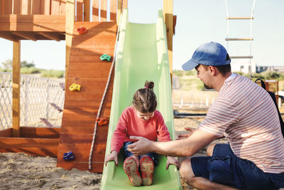 Couple sitting on building