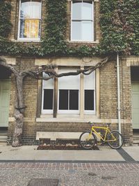 Bicycle on sidewalk against building