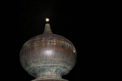 Close-up of illuminated lamp against black background