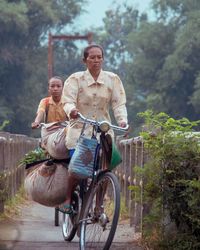 Man with bicycle on tree