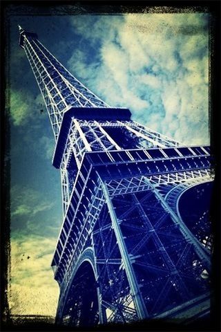 transfer print, low angle view, sky, built structure, architecture, auto post production filter, cloud - sky, metal, tower, tall - high, cloudy, metallic, building exterior, cloud, eiffel tower, day, no people, outdoors, culture, architectural feature