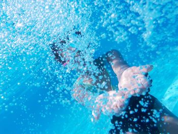 Teenage boy swimming underwater