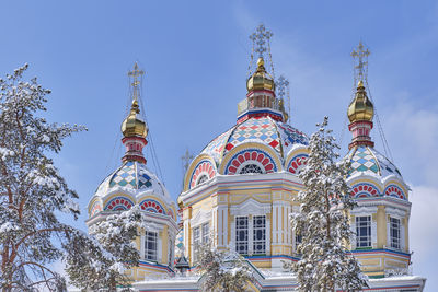 Domes of ascension cathedral in snow-covered in panfilov park, almaty, kazakhstan.